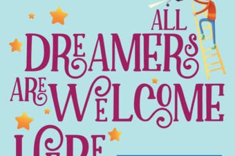 All Dreamer Are Welcome Here sign with person climbing a ladder