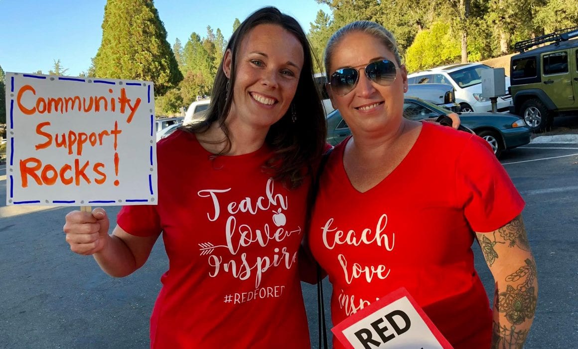 Two women teachers with teach love inspire #RedForEd shirts on