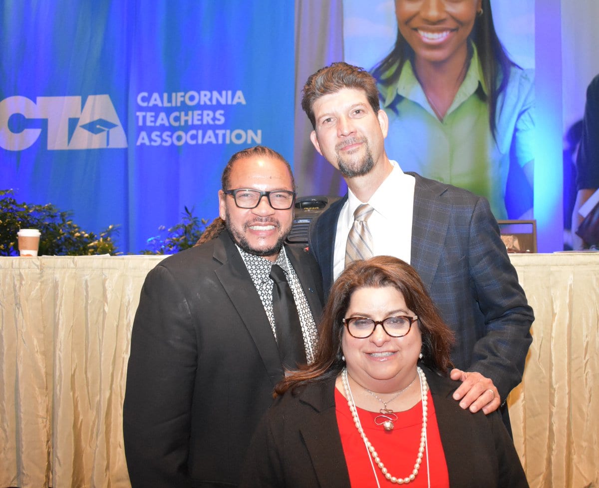 Three of CTA's Executive Officers standing and smiling at State Council