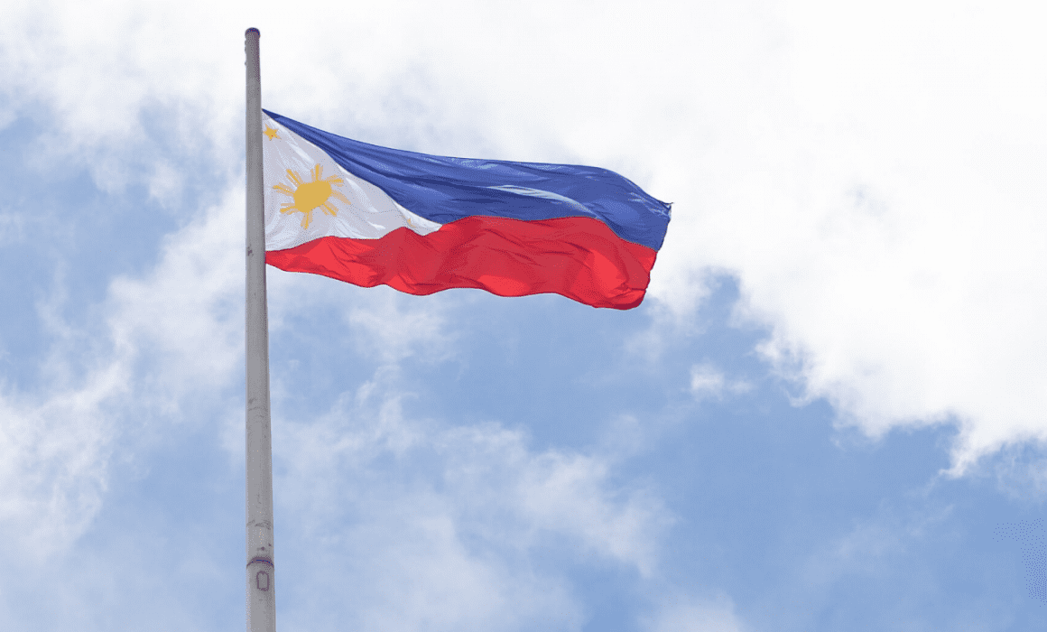 Flag of the Philippines with a blue sky in the background