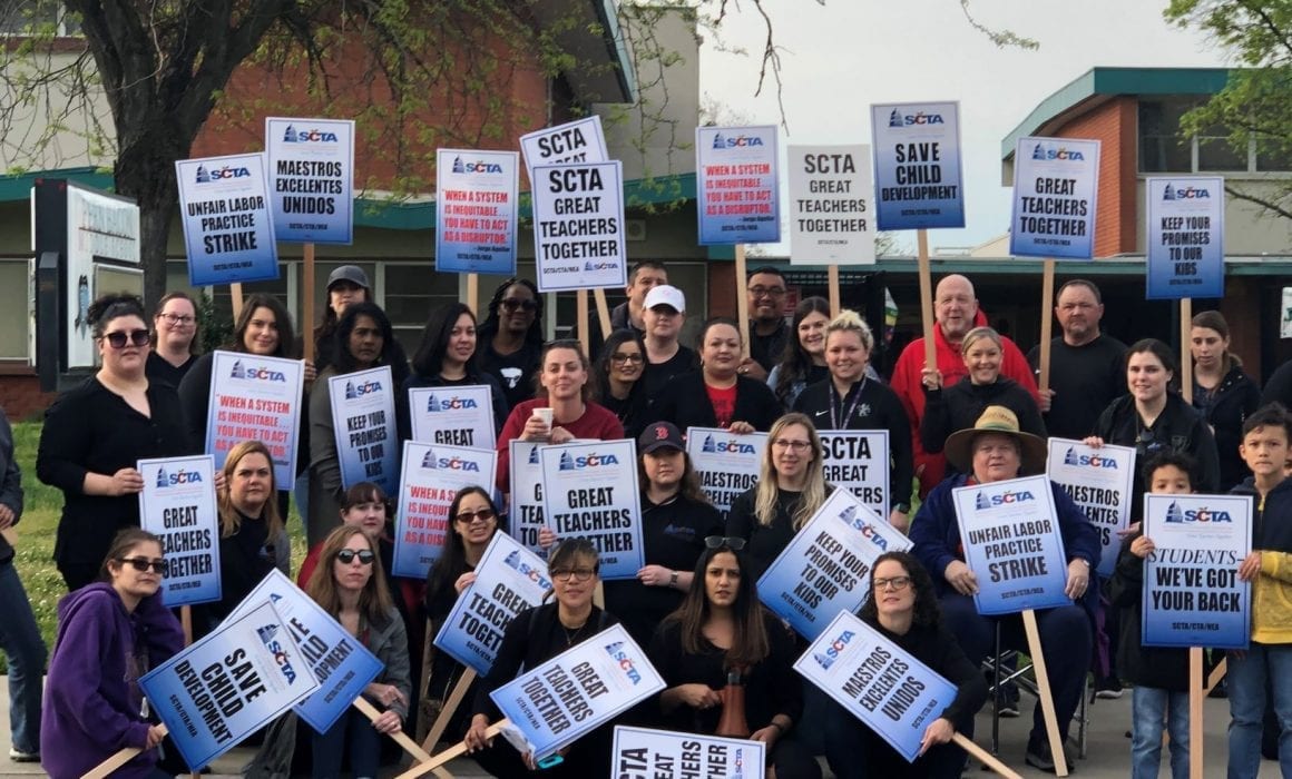 Sacramento Educators on Strike in 2019, holding picket signs and posing for a group photo