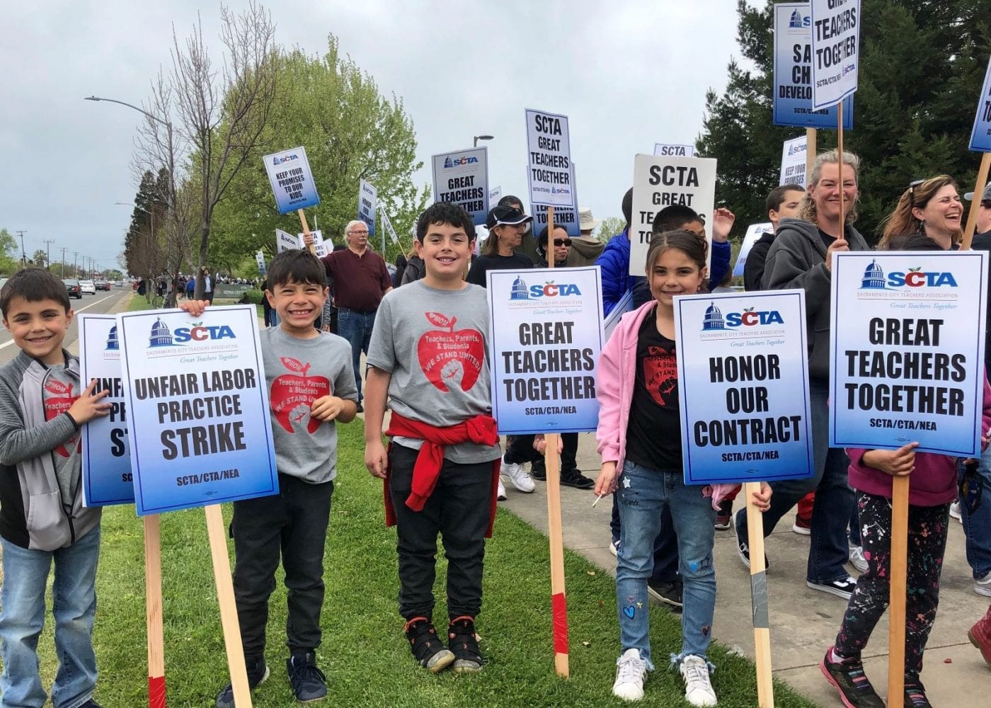 Students hold signs on the Sacramento City Teachers Association strike line in 2019