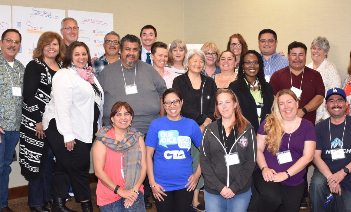 group of education support professionals standing and smiling