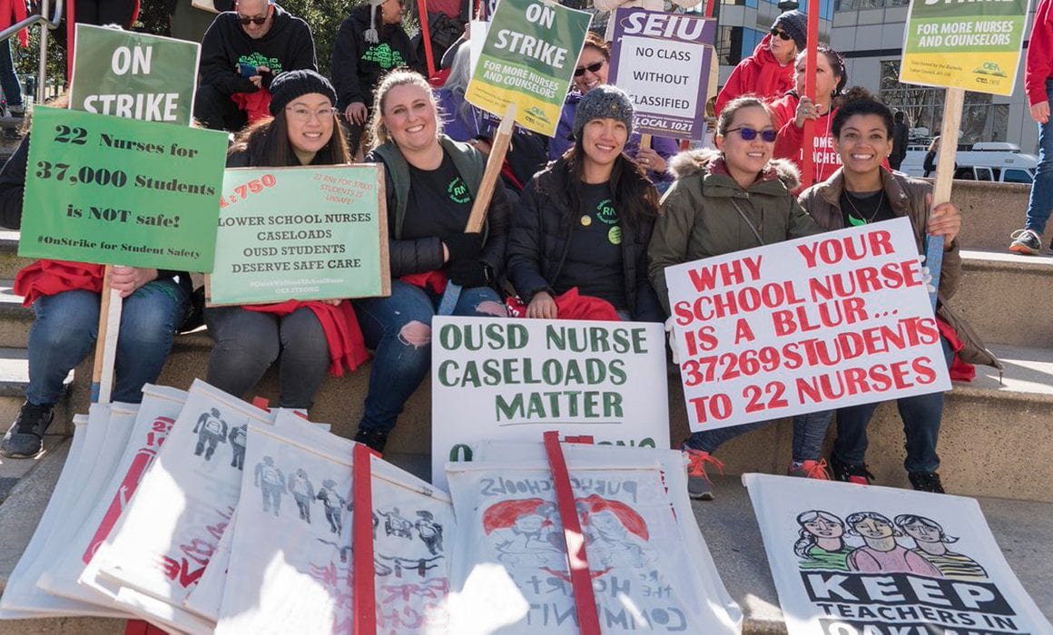 School nurses holding up support signs