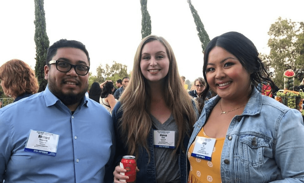 Three members of Student CTA smile at the camera.