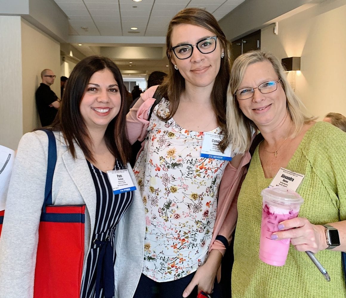 Three women teachers posing for photos at a CTA conference