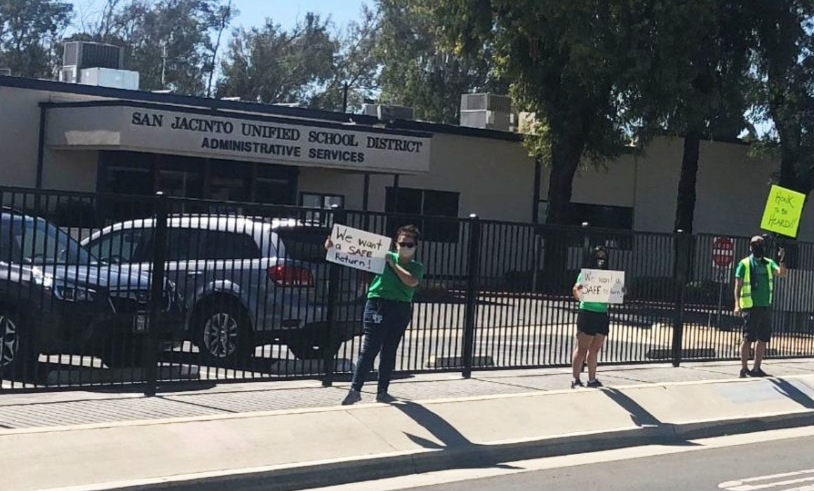 SJTA members maintain social distance during their organizing activity in front of SJUSD office