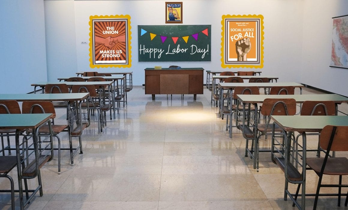 Classroom with desks all facing a chalkboard with the phrase "Happy Labor Day!" written on it with a garland above. There are two posters framing the chalkboard - one that reads "The Union makes us strong" and shows two hands shaking and another that reads "social justice for all" with a fist beneath it.