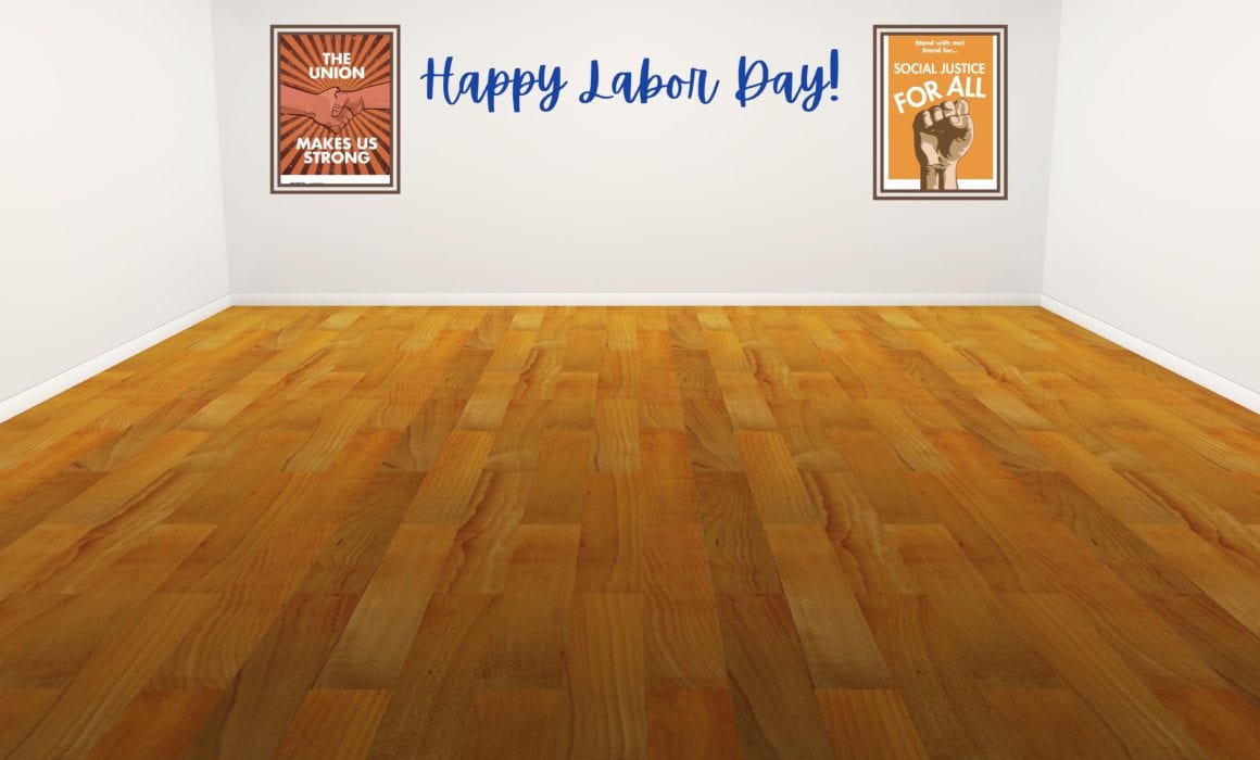 Hardwood floors leading to a white wall with the words "Happy Labor Day!" with two posters on either side. One reads "The Union makes us strong" and shows two hands shaking and another reads "social justice for all" with a fist beneath it.