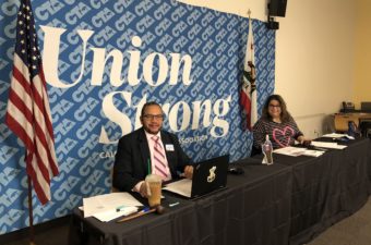CTA President Toby Boyd and CTA Secretary-Treasurer Leslie Littman sit at a dais with a CTA Union Strong banner behind them for the 2020 October Virtual State Council