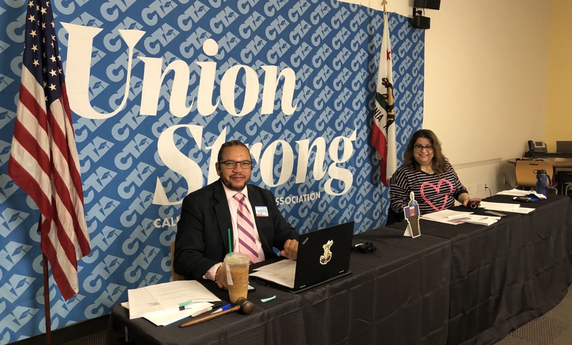 CTA President Toby Boyd and CTA Secretary-Treasurer Leslie Littman sit at a dais with a CTA Union Strong banner behind them for the 2020 October Virtual State Council