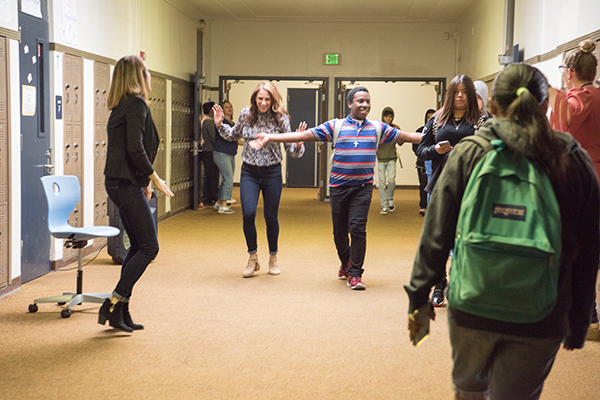 MacCaskey and Ortiz hold student dance party in the school hallway.