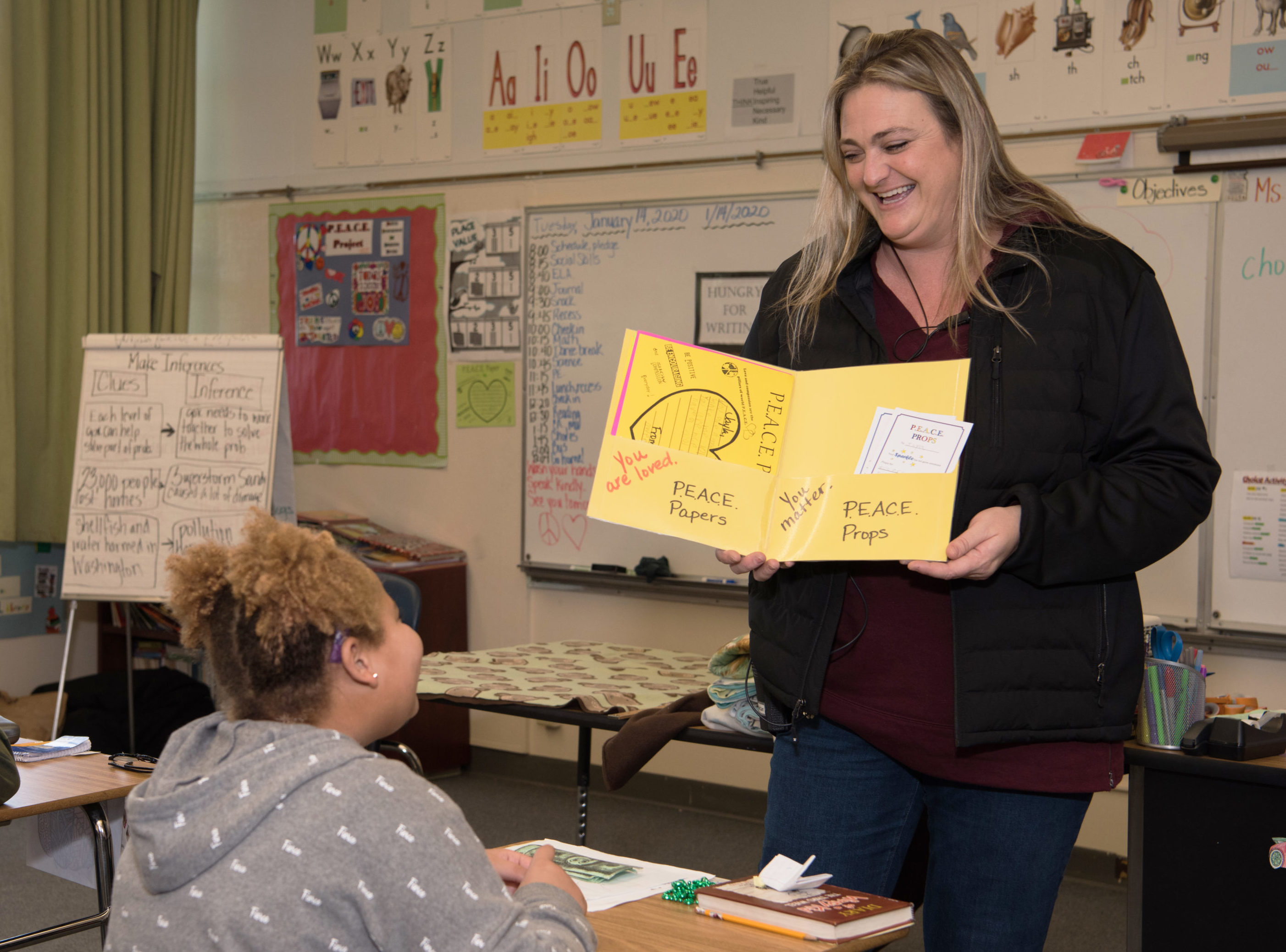 Alli McCart showing papers to students