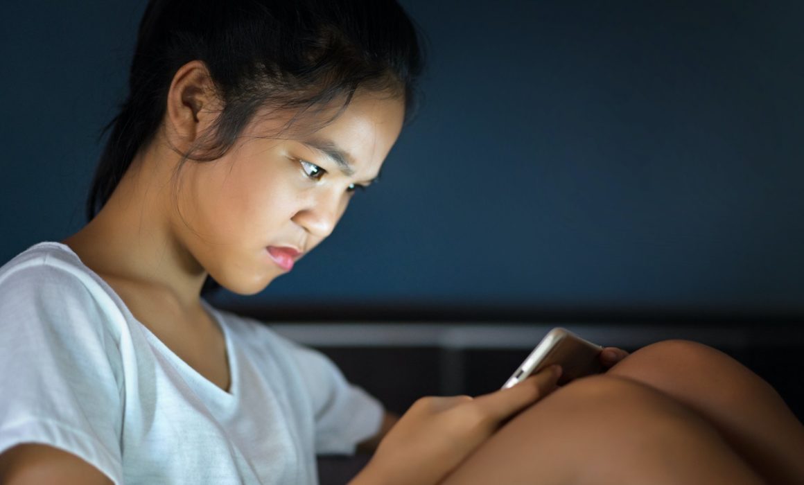 girl looking at cell phone