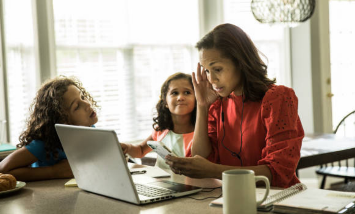 Getty photo (purchased) of woman working while children want her attention