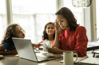 Getty photo (purchased) of woman working while children want her attention