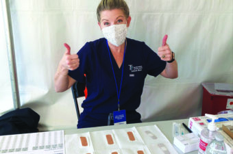 School nurse Shadlie Kensrue volunteers in the Orange County community to administer COVID-19 vaccines.