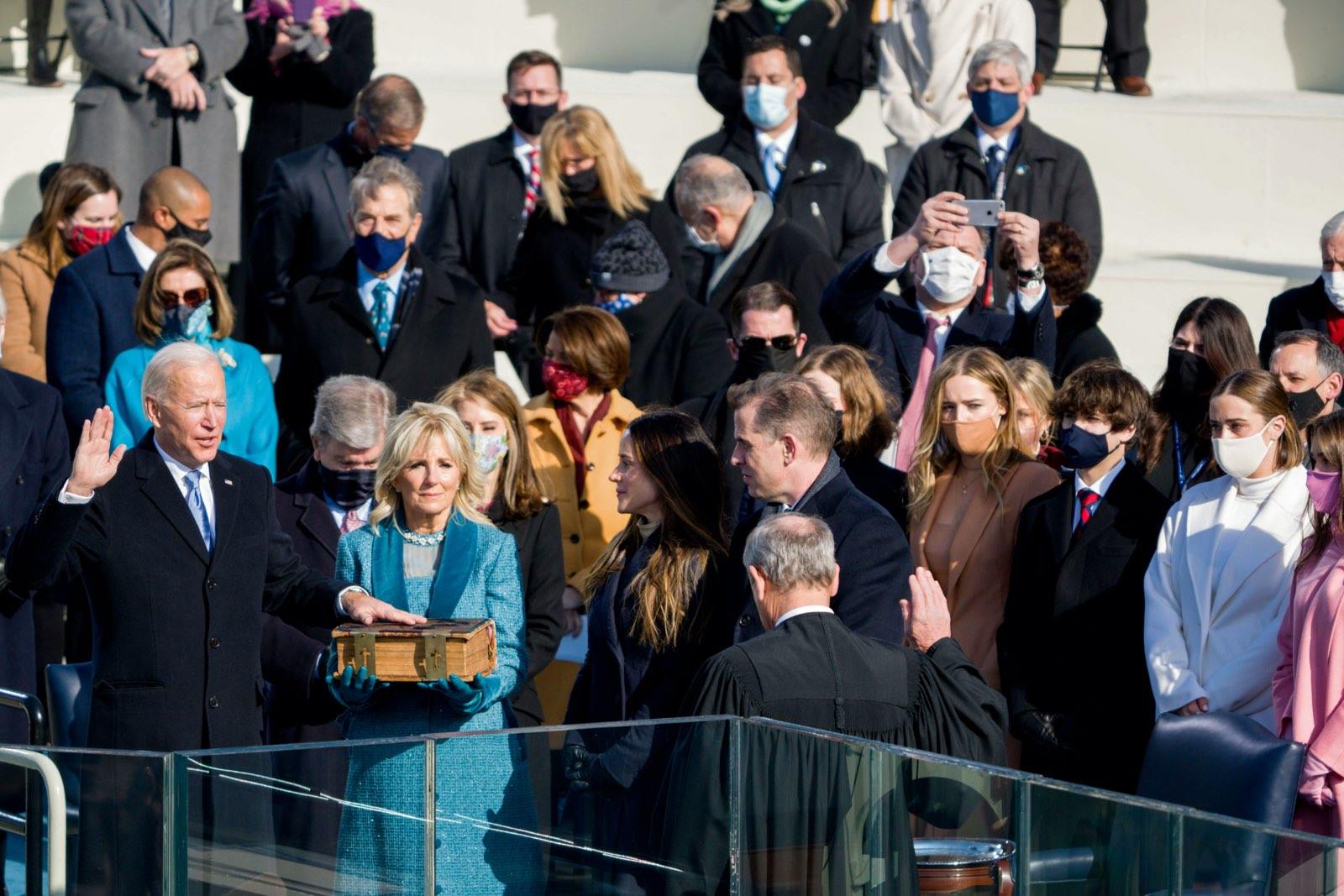 President Biden is sworn in by Chief Justice John Roberts, with first lady Jill Biden and members of his family in attendance.