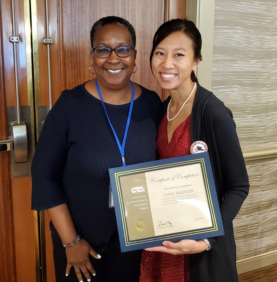 Chau Bao Nguyen, holding CTA EMEID Certificate of Completion, standing with her chapter president.