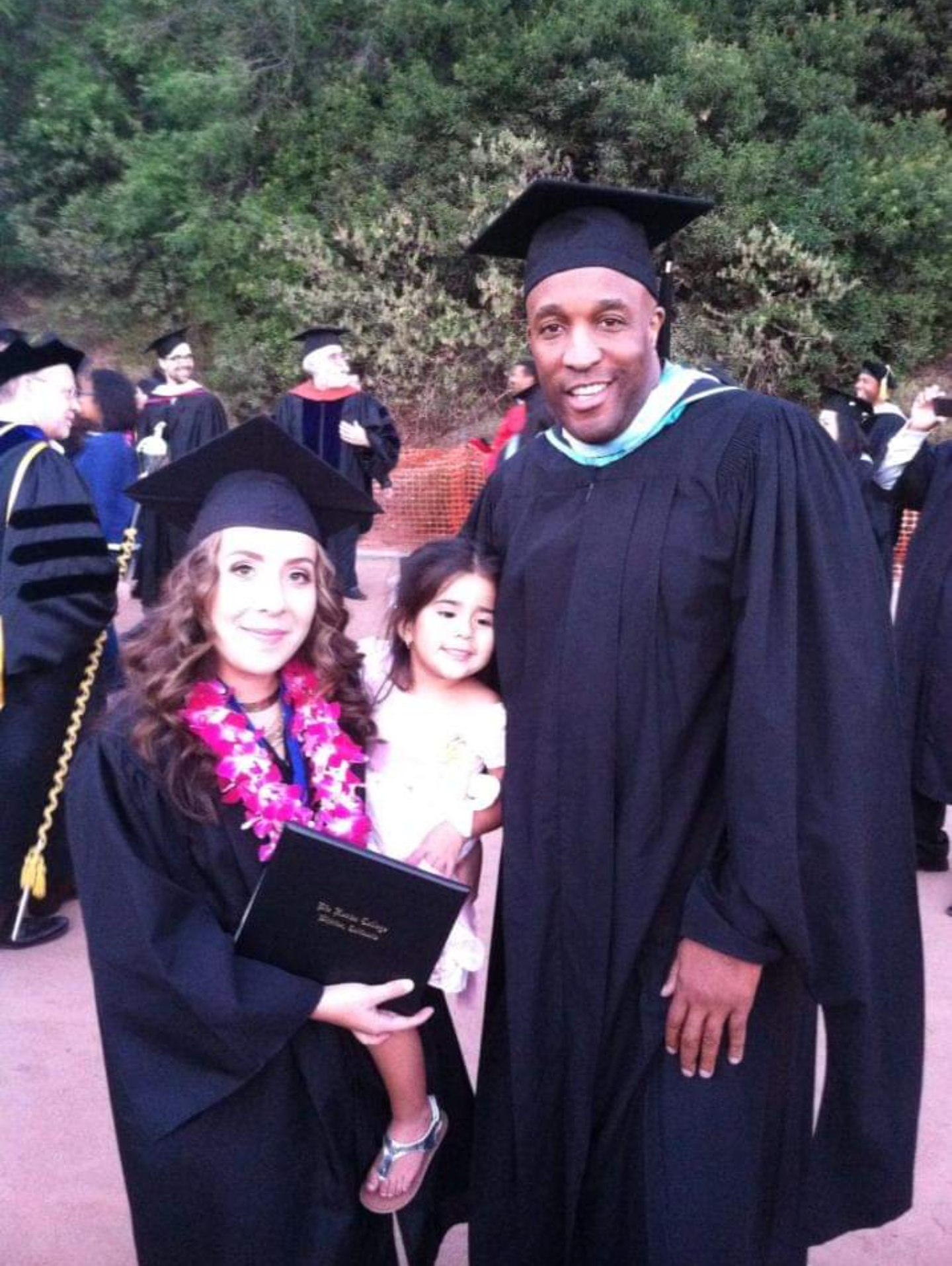 Thomas with student and her child on graduation day