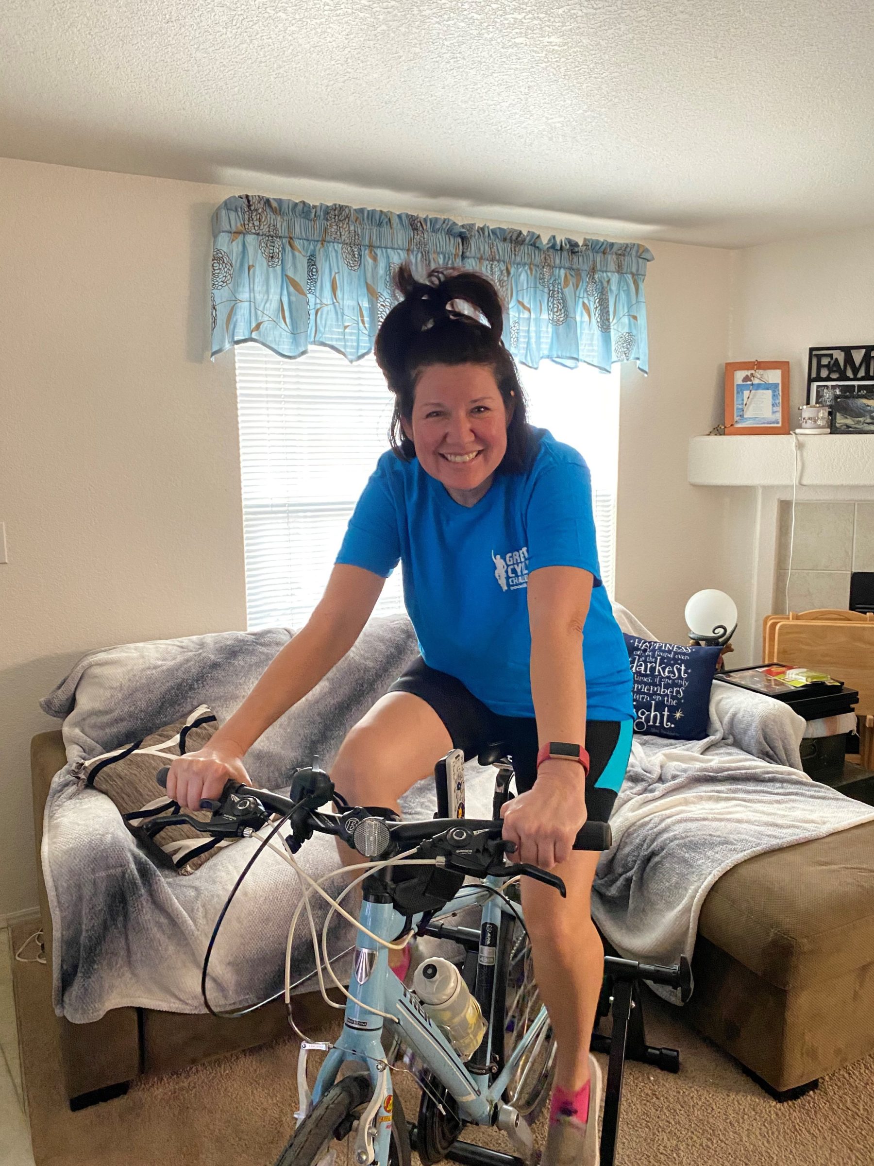 Woman riding stationary exercise bicycle.