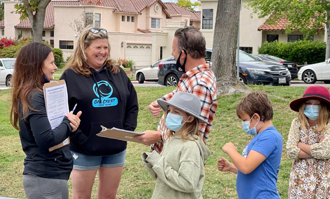 SDFA members gathering signatures on petitions outdoors