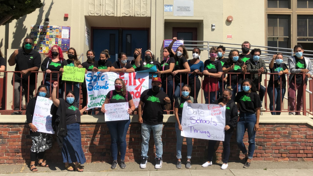 OEA President Keith Brown and educators in front of Melrose Leadership Academy, calling for safe, fully staffed, and adequately funded schools. 
