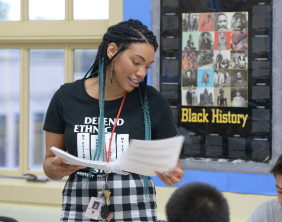 An educator wearing a "defend ethnic studies" t-shirt