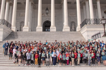 Large group of students on steps of U.S. Capitol.