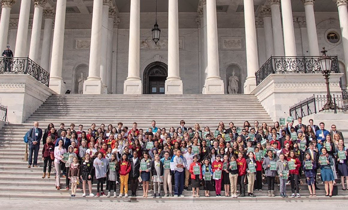 Large group of students on steps of U.S. Capitol.