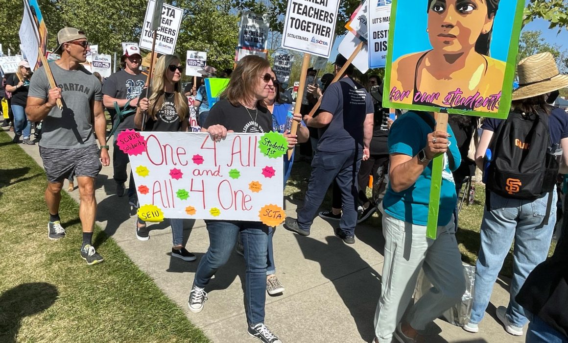 Sacramento educators hold protest signs during strike.