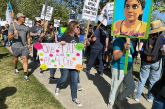 Sacramento educators hold protest signs during strike.