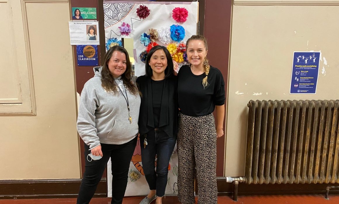 Three women smiling in room