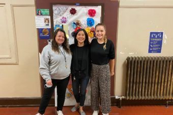 Three women smiling in room