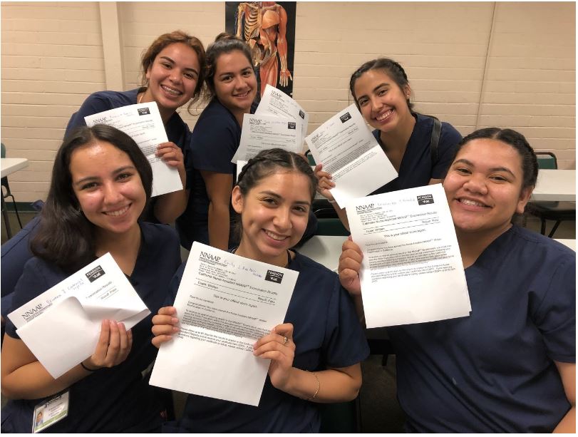 students holding up their certificates