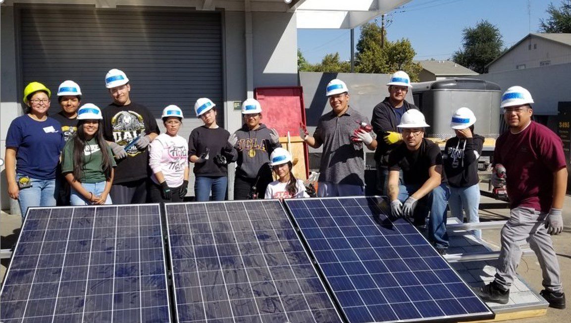 students learning how to install solar panels