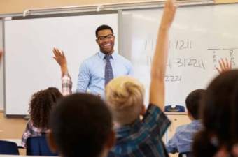 Picture of math teacher with students raising hands