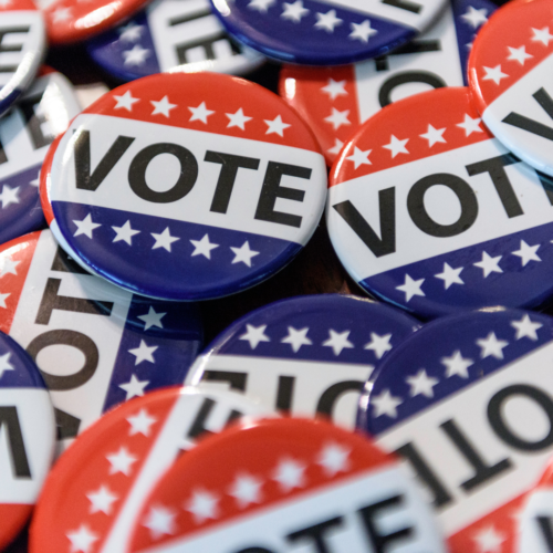 Pile of buttons with the word VOTE