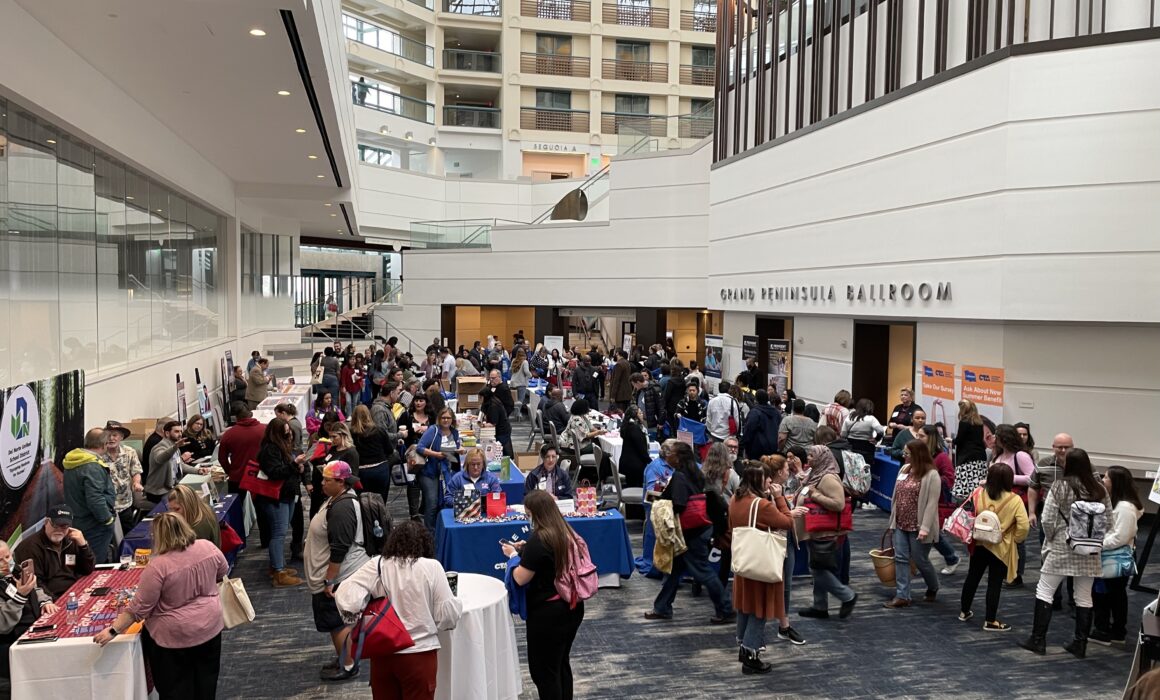 Exhibitor floor of Good Teaching Conference North. Educators checking out tables of exhibitors including California Reads, NEA Foundation, and more.