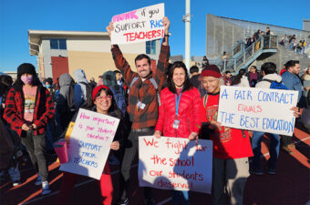 An image of United Teachers of Richmond members holding rally signs.