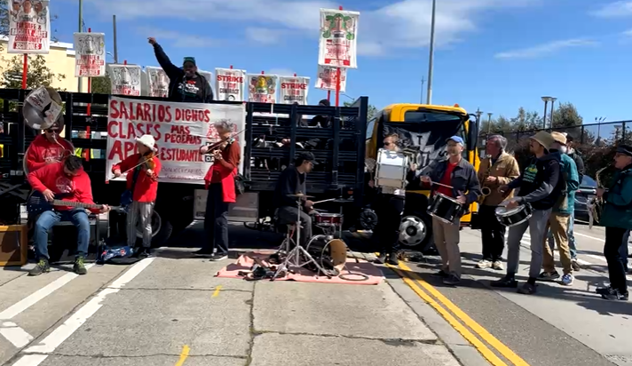 An image of musicians playing instruments at the Oakland Education Association strike rally in May 2023. 