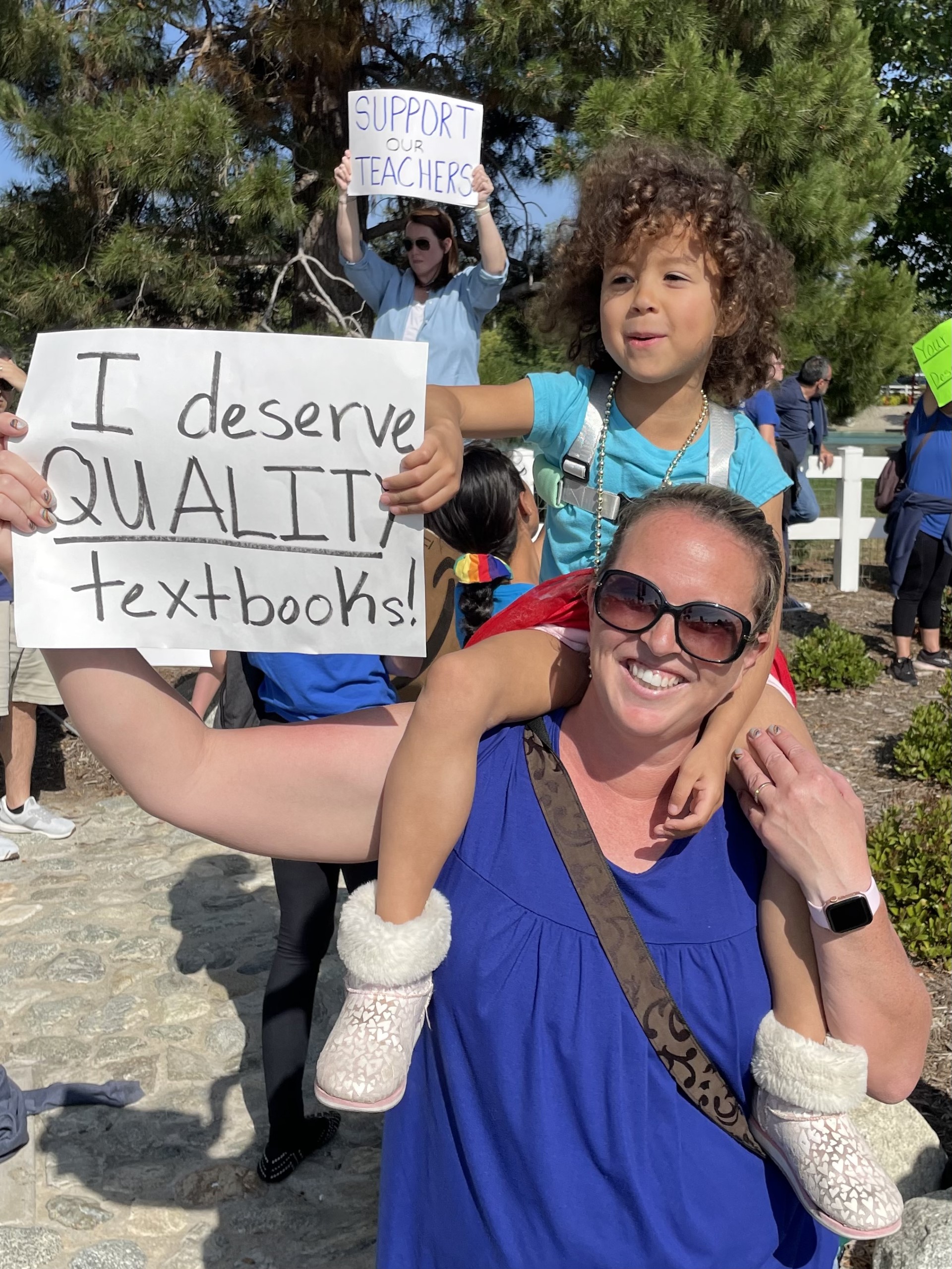 Mom holding a rally sign with her daughter