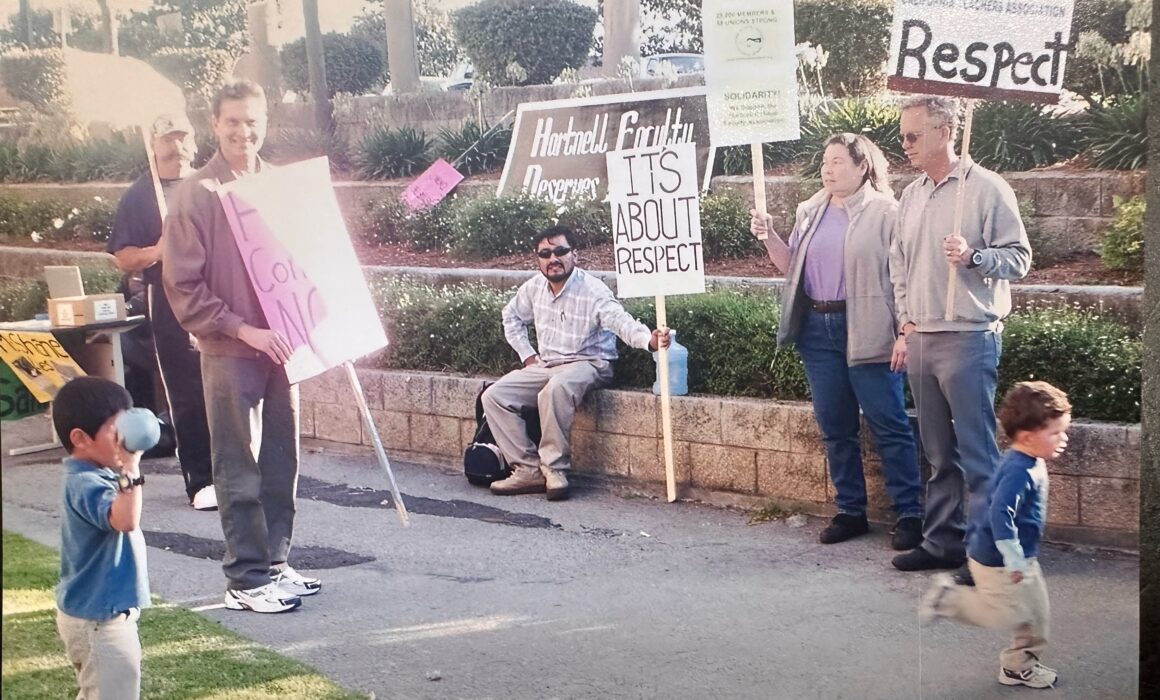 Hartnell - Group of people holding signs