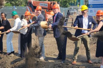 a group of people wearing orange hard hats