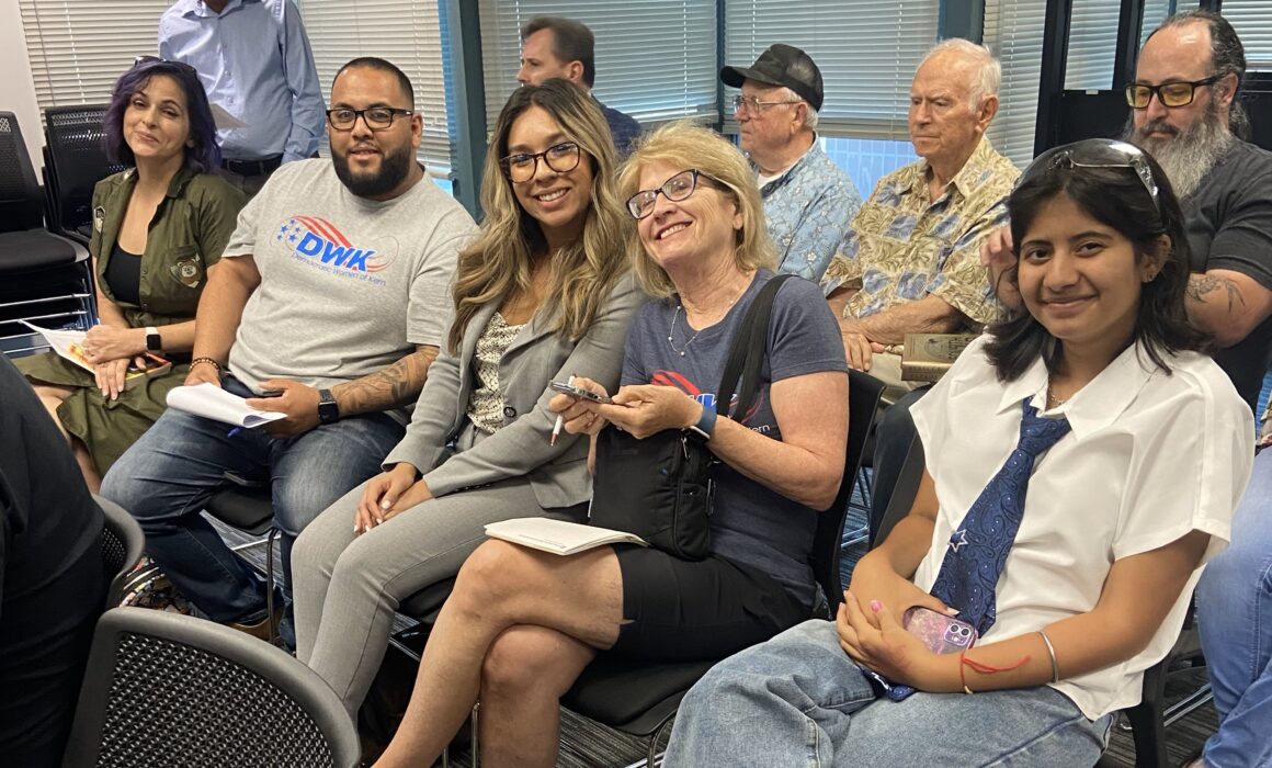 Coalition members against the proposed “outing” policy show support at the Kern school board meeting