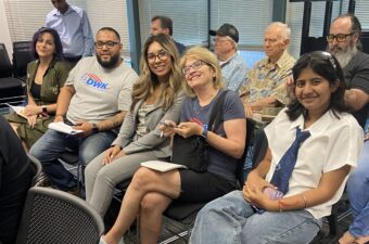 Coalition members against the proposed “outing” policy show support at the Kern school board meeting