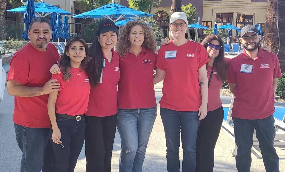 A group of people wearing red t-shirts.