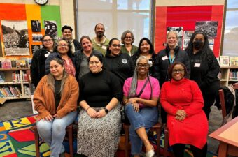 A group of people sitting and posing for a photograph. They belong to the West Contra Costa County Community Schools Support Collaborative