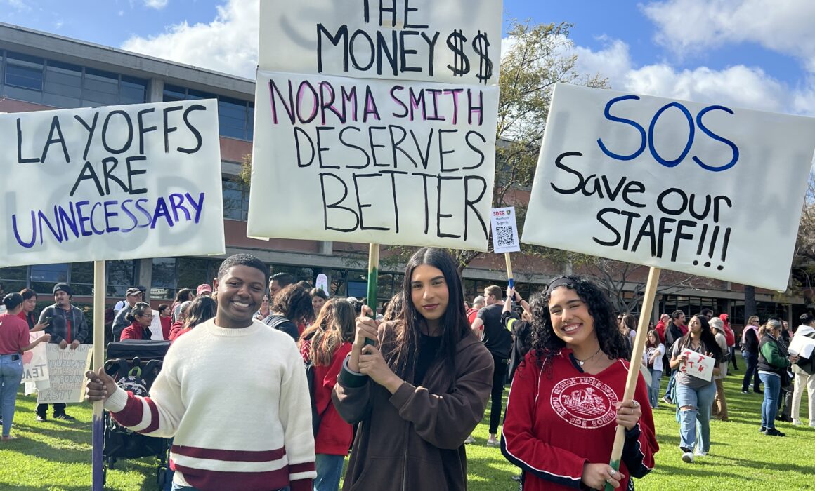 three women holding signs