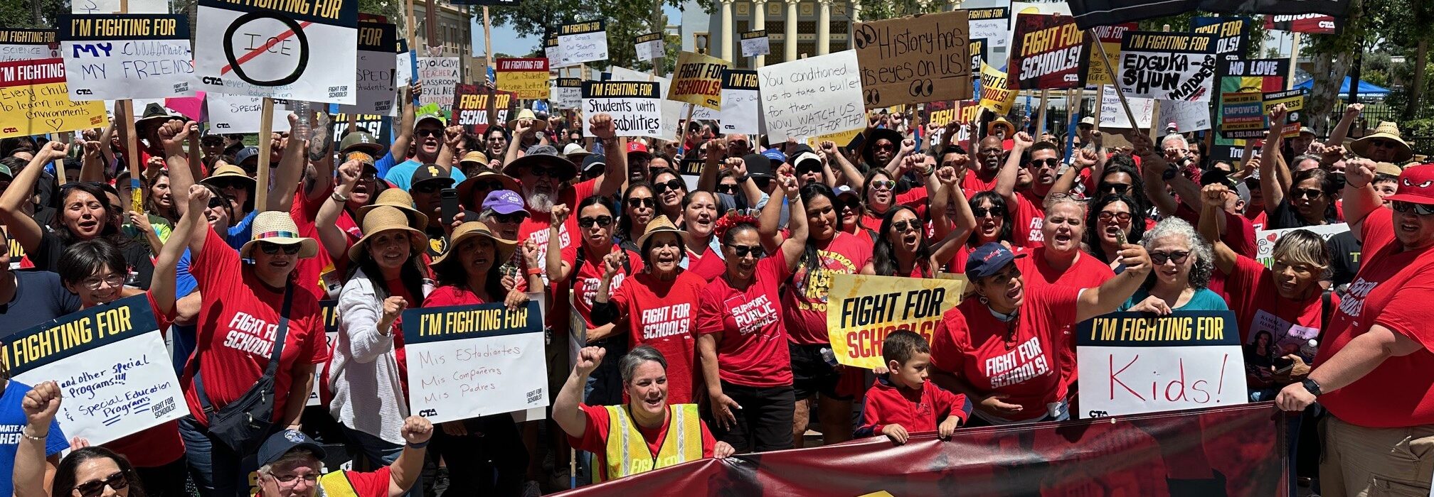 Labor activist Dolores Huerta, center, stands with the crowd in Hanford to defend and protect students, public schools and communities.